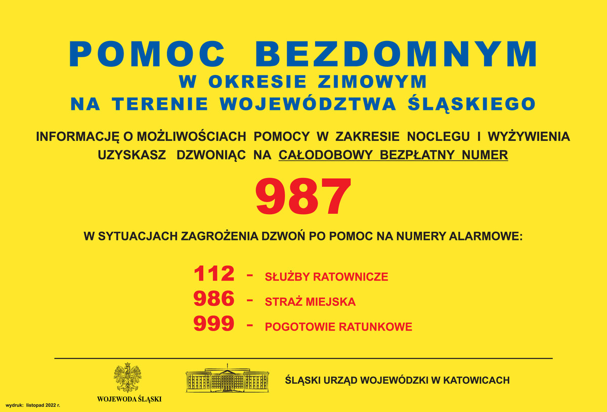 Żółty plakat o treści: pomoc bezdomnym w okresie zimowym na terenie województwa śląskiego. Informację o możliwościach pomocy w zakresie noclegu i wyżywienia uzyskasz dzwoniąc na całodobowy bezpłatny numer 987. W sytuacjach zagrożenia dzwoń po pomoc na numery alarmowe:112-służby ratownicze 986-straż miejska 999-pogotowie ratunkowe.