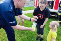 policjant rozdaje odblaski dzieciom