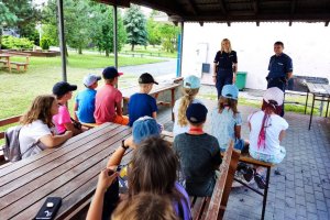 umundurowani policjanci w trakcie pogadanki z uczestnikami obozu
