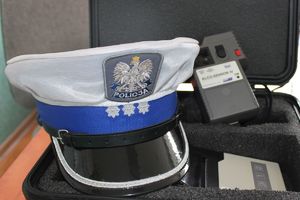 Czapka policjanta ruchu drogowego oraz alcosensor.