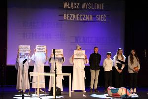 Zdjęcie przedstawia dziecięcą grupę teatralną podczas spektaklu.