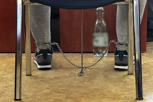 Zdjęcie przedstawia nogi z założonymi kajdankami zespolonymi.
