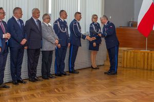 Zdjęcie przedstawia Zastępcę Komendanta Wojewódzkiego wręczającego list Komendantowi Powiatowemu. Obok stoją inni policjanci oraz goście.