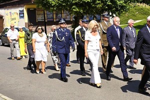 uczestnicy obchodów maszerują oraz składają wiązanki kwiatów pod miejscami pamięci narodowej