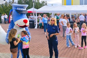 umundurowane policjantki wraz z grupą młodzieży i dzieci oraz sznupek