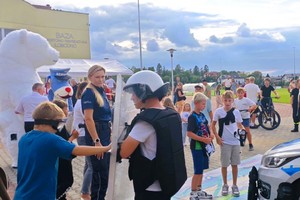 umundurowane policjantki wraz z grupą młodzieży i dzieci oraz sznupek